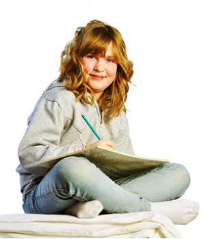Image of girl sitting cross-legged, writing
